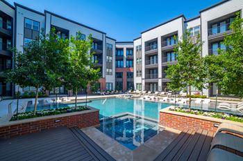 A swimming pool in front of some apartment buildings